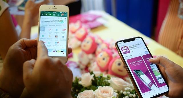 E-wallet firms battle for slice of cashless payment pie